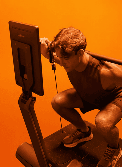 LYQUID machine with barbell attachment