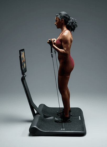 Side view of woman doing bicep curls on LYQUID