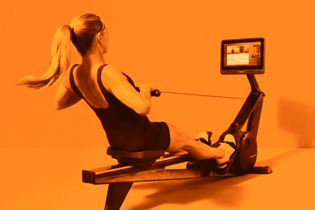Woman using Hydrow rowing machine during a workout