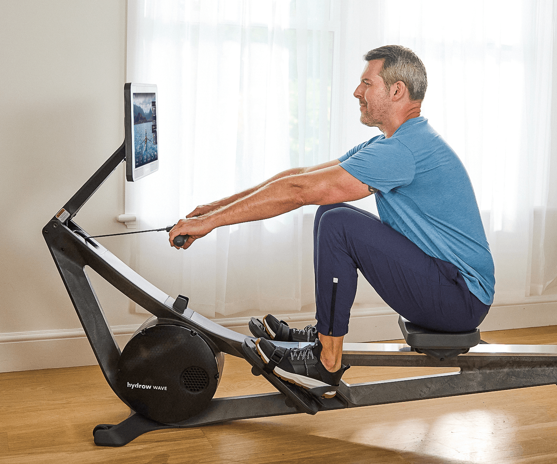 Man using Hydrow Wave Rower for a workout